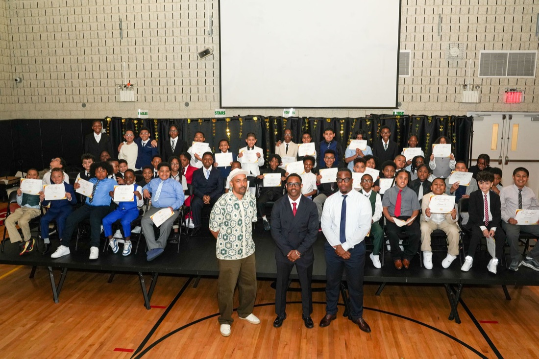 Young men hold their certificates at the Brotherhood induction.