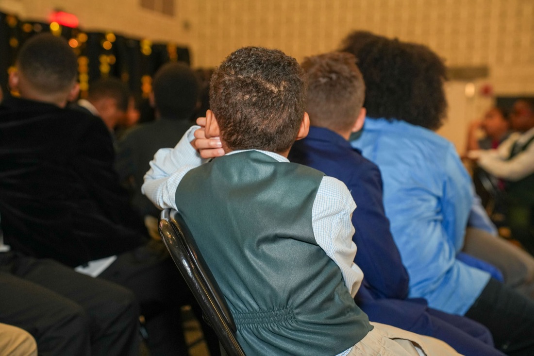 A young man receives his Brotherhood certificate.