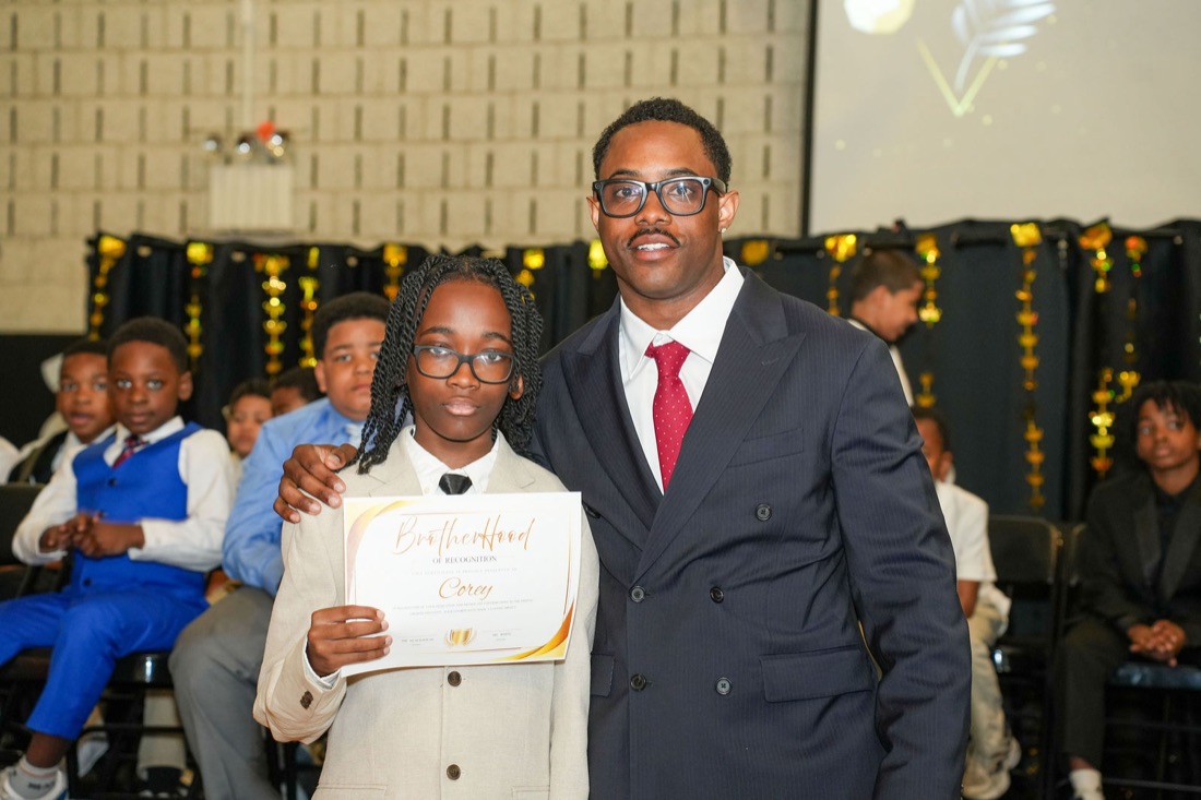 An inductee with his certificate on stage.