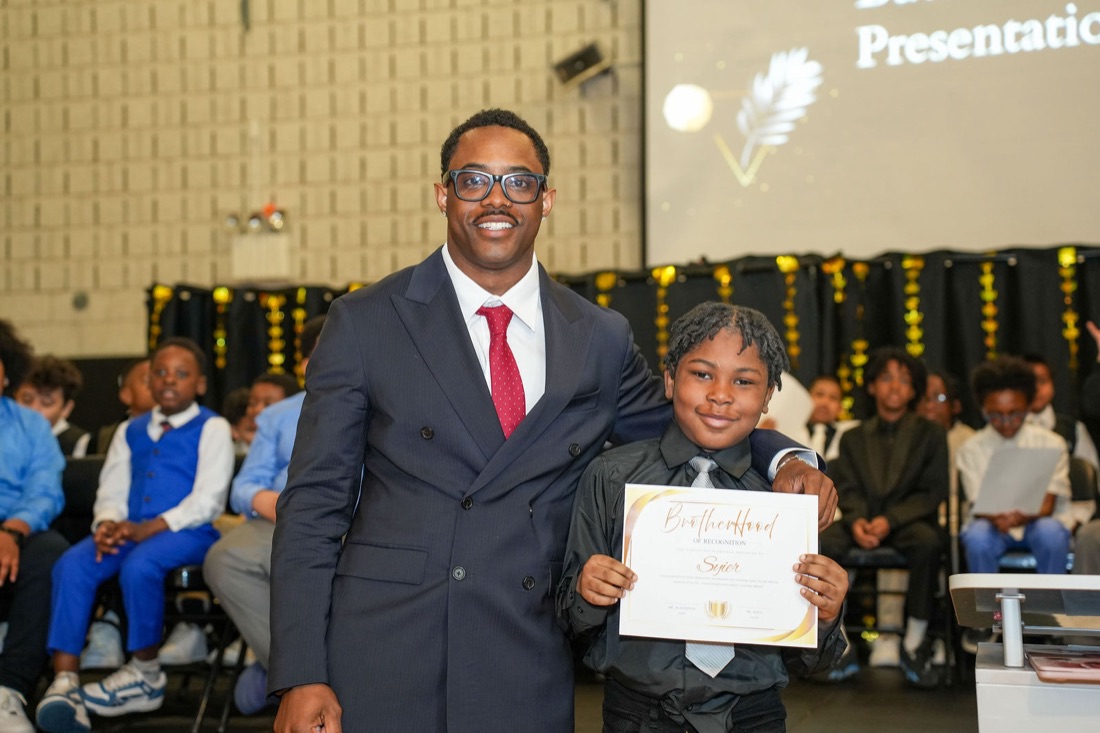 An inductee receives his Brotherhood certificate.