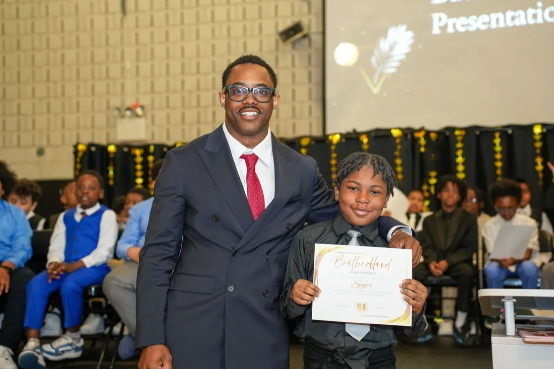 An inductee receives his Brotherhood certificate.