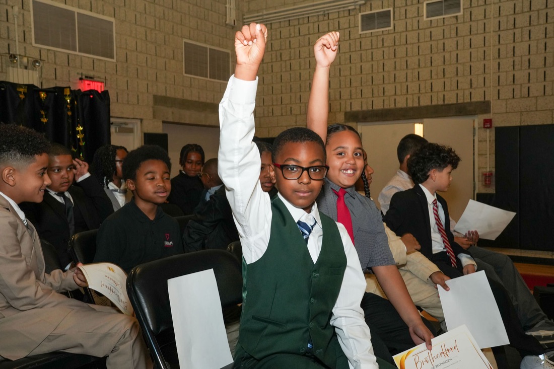 An inductee raises his fist in celebration.