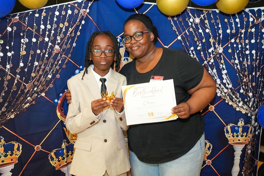 A young man celebrates with family after induction.