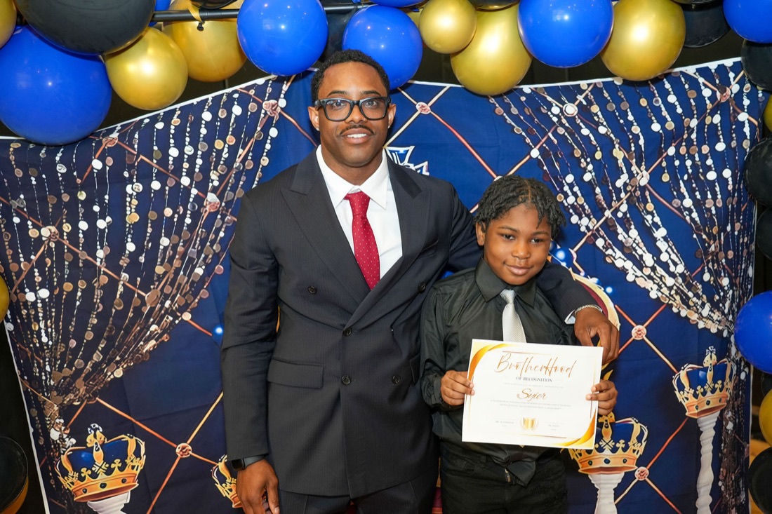 A young man with loved ones after the ceremony.